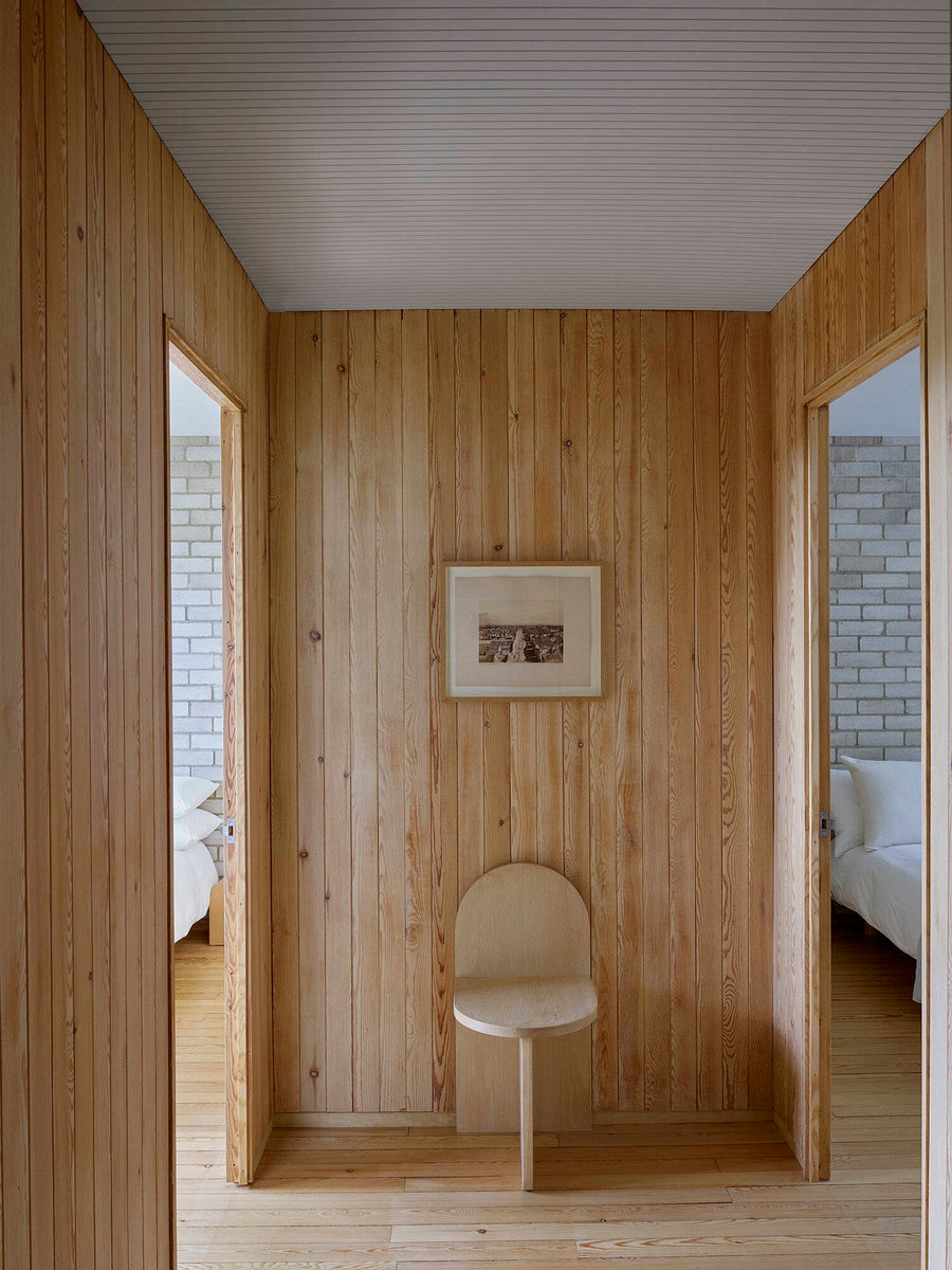 Wood Tombstone Chair in a hallway